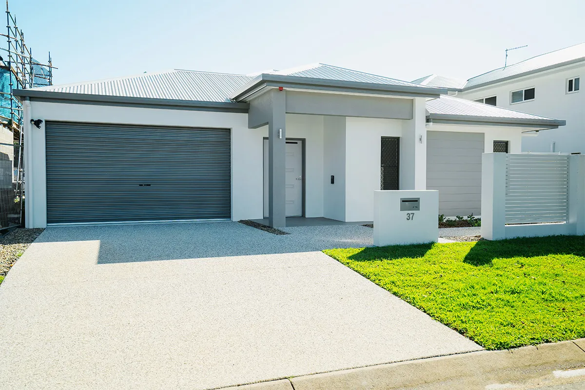 The front of a house with a lawn and garage